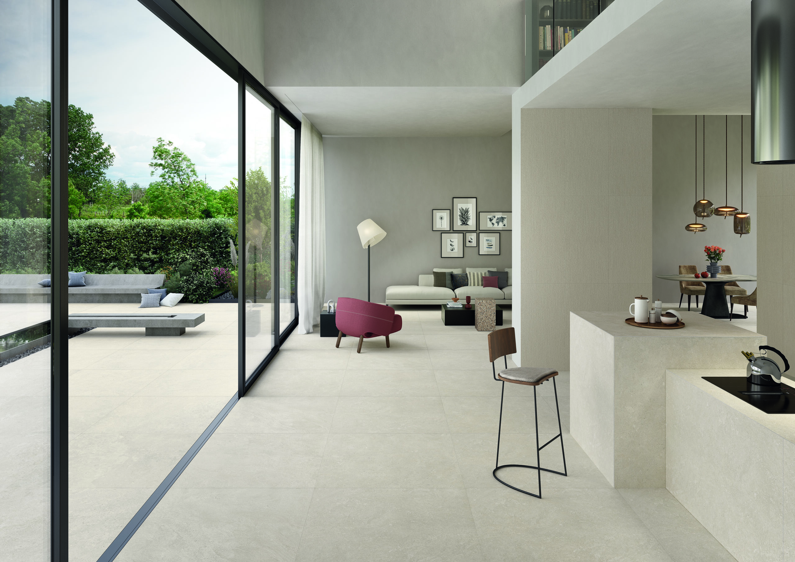 Binnen-buitenconcepten met doorlopende betonlook tegelvloer, modern open interieur met glazen schuifwand naar tuin, naadloze overgang tussen woonkamer en terras, wit keukeneiland met hangende koperen lampen